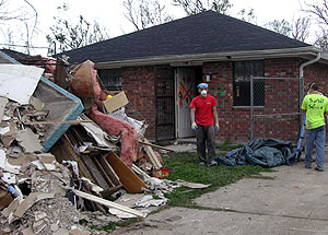 Sophomore Ray Deng (left) and Eric Sinn, brother of WUSTL sophomore Brian Sinn, remove garbage from a house in New Orleans during a spring-break trip to assist victims of Hurricane Katrina.