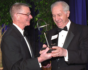 Eliot Society President Robert L. Virgil, Ph.D. (left), presents Murray L. Weidenbaum, Ph.D., with the Search Award at the society's 39th annual dinner April 26 at The Ritz-Carlton, St. Louis.