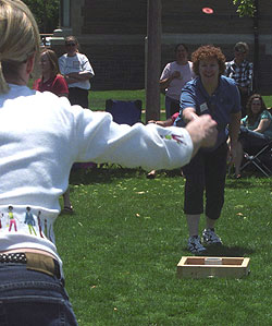 Competitors throw washers in the second year of the washers tournament.