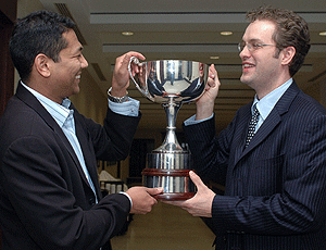 MBA student Peter K. Braxton (left) shares the Olin Cup with Daniel McChesney, chief executive of NeuroLife Noninvasive Solutions, after their firm won the business competition Feb. 1.