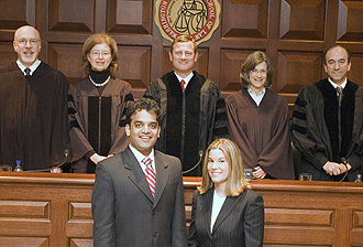 Samir Kaushik (front left) stands victorious beside fellow School of Law student Renee Waters after winning the Wiley Rutledge Moot Court Competition Feb. 6. The pair successfully argued their case before Chief Justice of the United States John G. Roberts Jr. (back center).