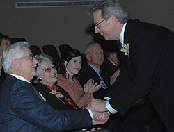 Jeff Pike (right) greets Herbert F. Hitzeman Jr. at the installation ceremony. Jane Reuter Hitzeman is to her husband's left.