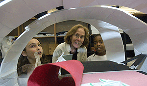 Gay Lorberbaum (center) examines a proposed science center with fourth-graders Catherine Cavin (left) and Brianna Stanfield (right). The project is part of a new K-12 program in architecture that Lorberbaum created for the Sam Fox School of Design & Visual Arts.