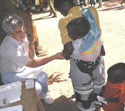 Mark Manary, M.D., professor of pediatrics, assesses patients for malnutrition at a clinic in Malawi, Africa. Manary has worked there for several years, feeding malnourished toddlers an enriched peanut-butter product that can restore these children to hea