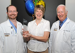 Jacquelyn Fleming receives the Deans Operations Staff Award. Pictured (L-R) are: John Kirby, M.D.; Fleming; and Larry J. Shapiro, M.D.