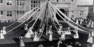 Women students in 1908 dance around the Maypole