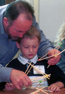 Michael Nobs works with his son, Benjamin, to build a structure