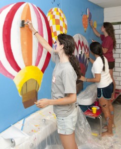 Among the myriad projects WUSTL students can participate in during Service First include painting murals at local elementary schools.