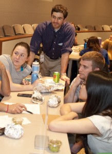 David Levine (center) works with fellow students at an April 18 interdisciplinary case study at the School of Medicine. A former high school chemistry teacher, he will take his collaborative nature to NYU this summer to begin his residency in internal medicine-primary care.