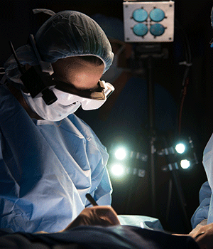 Surgeon in scrubs wearing goggles