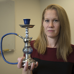Melissa J. Krauss, a research statistician in Washington University’s Department of Psychiatry, holds a hookah pipe. She found that positive mentions about hookah smoking on Twitter may promote the assumption that it is less harmful than smoking cigarettes, when hookah smoking has many of the same harmful toxins as cigarettes.