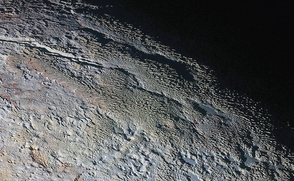 Regarding the “bladed” terrain on ­Pluto, McKinnon says, “It’s a unique and perplexing landscape stretching over hundreds of miles, and it looks more like tree bark or dragon scales than geology. This will really take time to figure out. Maybe it’s some combination of internal tectonic forces and ice sublimation driven by Pluto’s faint sunlight.” (NASA/JHUAPL/SwRI)