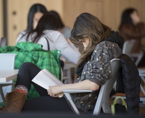 A female student reads a book.
