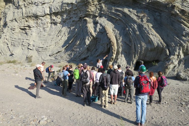 Trinity College professor Quentin Crowley explaining to a group of Washington University and Trinity College geology students the formation of the Grodo megabed in the Tabernas Basin of Anadlucia in southeast Spain. He stands in front of rock layers deformed by a landslide that triggered a tsunami.