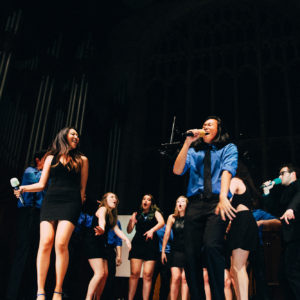 students sing at a cappella show