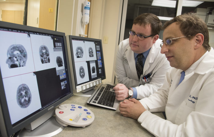 Study authors Beau M. Ances, MD, PhD, (right) associate professor of neurology at Washington University School of Medicine in St. Louis, and Matthew R. Brier, an MD/PhD student at the university, examine PET (positron emission tomography) scans of Alzheimer’s disease patients. (Photo: Robert Boston/School of Medicine)