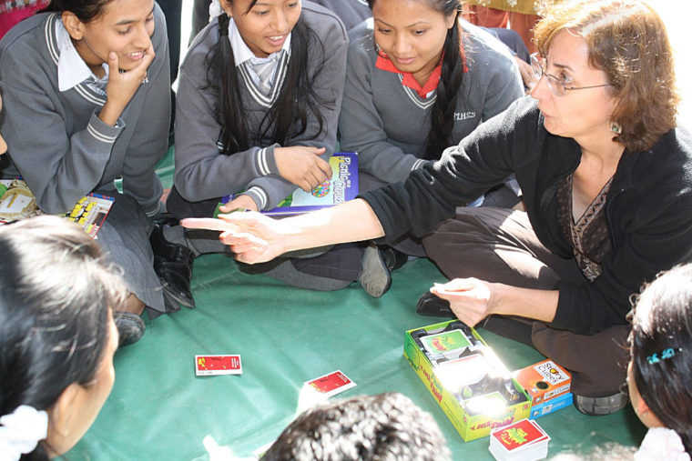 Cathy Raymond playing a game with children in Nepal