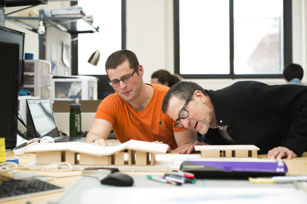 Bruce Lindsey, dean of the College of Architecture and Graduate School of Architecture & Urban Design, works with students in Givens Hall. (Photo: Joe Angeles/Washington University)