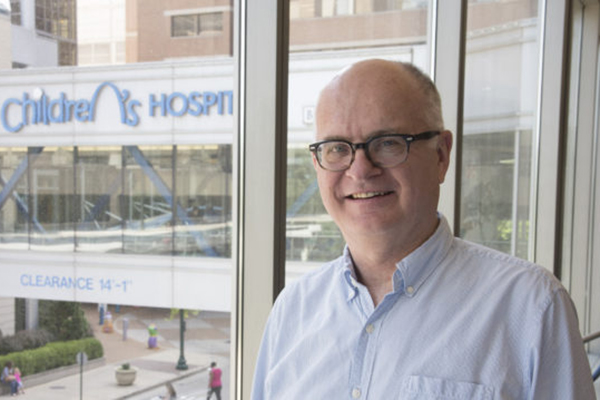 Brian P. Hackett, MD, PhD, professor of pediatrics, with St. Louis Children's Hospital in background