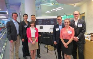 The Memento team poses with a poster detailing its new Alzheimer's disease diagnostic tool.