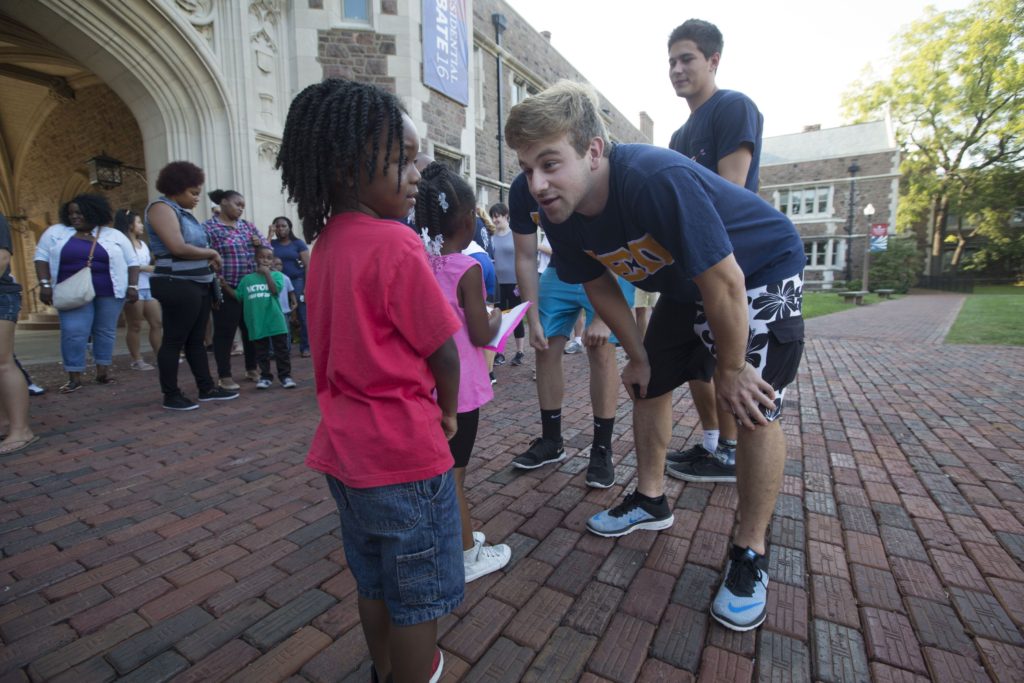 SATURDAY, SEPT. 24, 2016 - Washington University student Ilan Wallentin, a member of the Alpha Epsilon Pi fraternity, talks with Camden Butler, 5, Saturday during Greek Day of Service, now an annual tradition, that hosts dozens of KIPP families on the Wash U campus. Young "KIPPsters" and their parents toured campus and participated in activities. The program gives young students a look at college life. Photo by Jerry Naunheim Jr./WUSTL Photos
