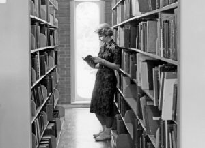 In 1960, a student (not locked in) finds a quiet place to read in Gaylord Music Library. 