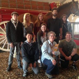 students and professor pose in front of Clydesdale