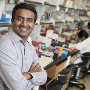 Headshot of professor Srikanth Singamaneni, standing in a lab