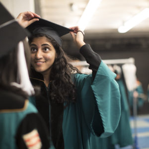 student adjusts graduation cap
