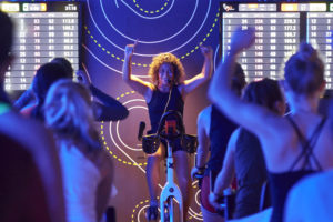 Cycling instructor Meghann Feely, assistant director of fitness and wellness, models her spinning classes after the popular fitness craze SoulCycle. (Dan Donovan/Washington University)