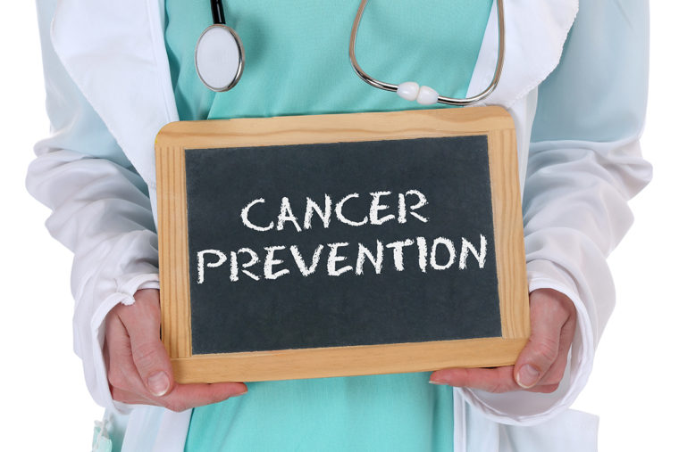 doctor with chalkboard reading "cancer prevention"