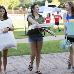 students move belongings in