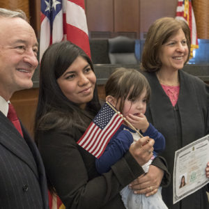 Chancellor Mark S. Wrighton was the guest speaker at a Dec. 8 naturalization ceremony during which 52 people became U.S. citizens. Wrighton greeted and had pictures taken with all the new citizens, including Geraldine I. Cunningham (center), a native of Peru. The Honorable Audrey G. Fleissig (right), JD ’80, U.S. States District Judge for the Eastern District of Missouri, presided over the ceremony, held at the Thomas F. Eagleton Courthouse in St. Louis. (Photo: Joe Angeles/Washington University)