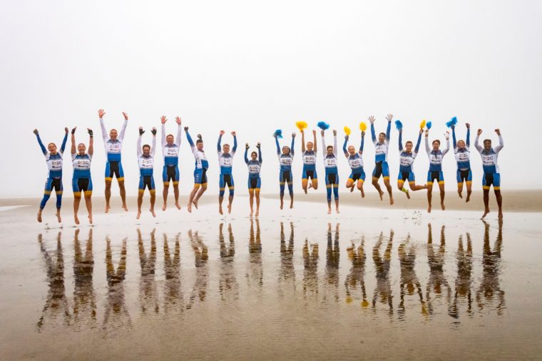Bristol Myers-Squibb employees jump for joy on the beach