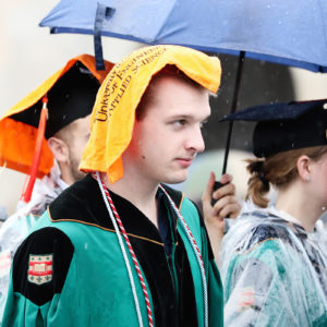student with towel at Commencement