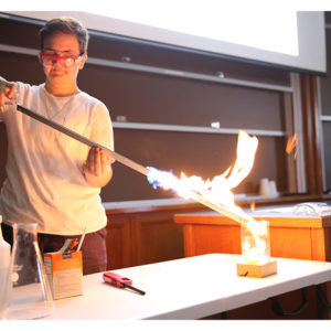 Student blowing glass