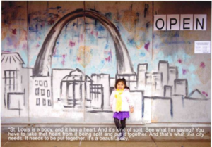 Little girl underneath a painting of the Arch