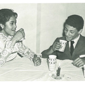 Malcolm Ryder, the first black student to live in The Westminster School's boy's dormitory beginning in the fall of 1968, enjoys a drink with Janice Kemp, one of three black girls who desegregated Westminster in 1967. Image from 1969 Lynx Yearbook, courtesy of Beck Archives-Westminster.
