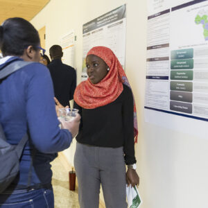 student presents research poster