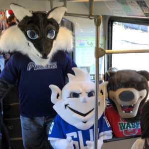 Mascots riding the train