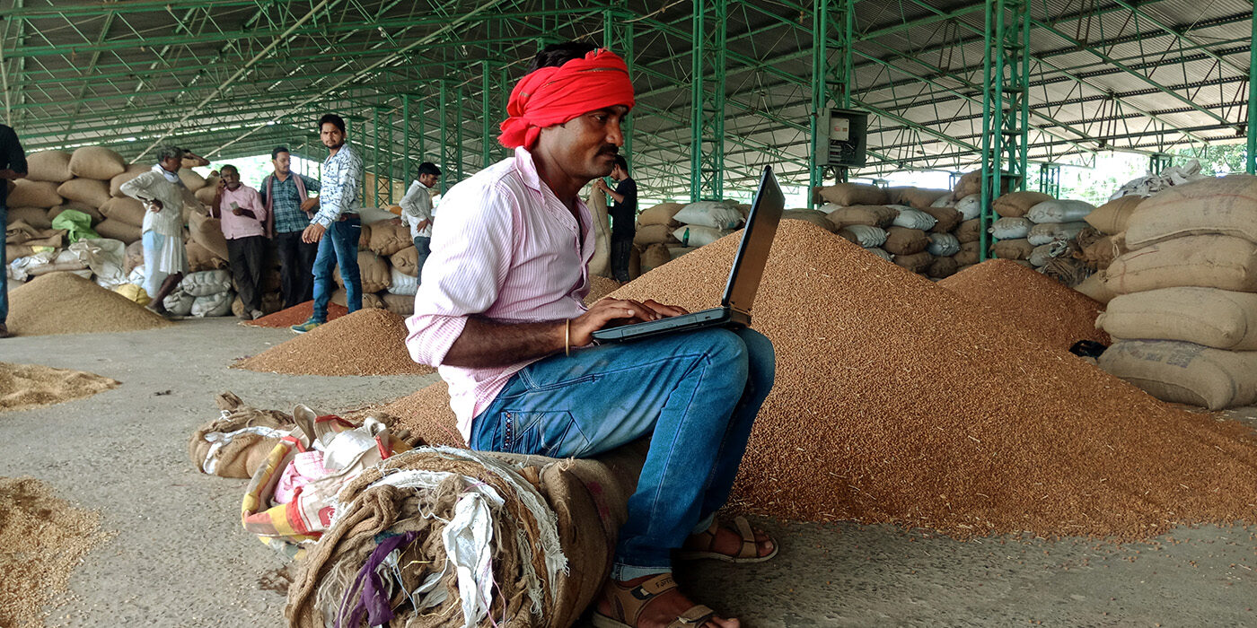 farmer seated with laptop