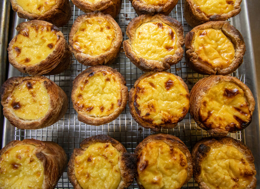 Portuguese-style egg tarts cooling