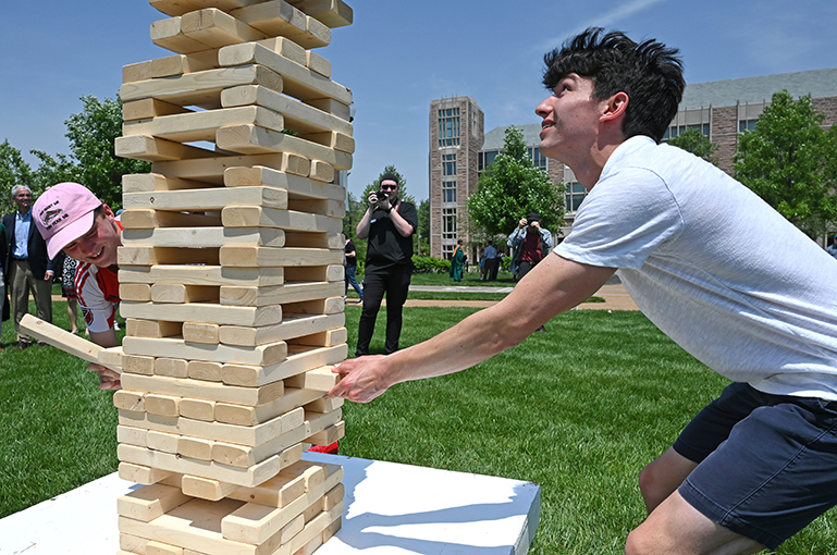 After the ceremony, graduates and their guests relaxed with games like Jenga (above) and cornhole, scattered throughout the Danforth Campus.