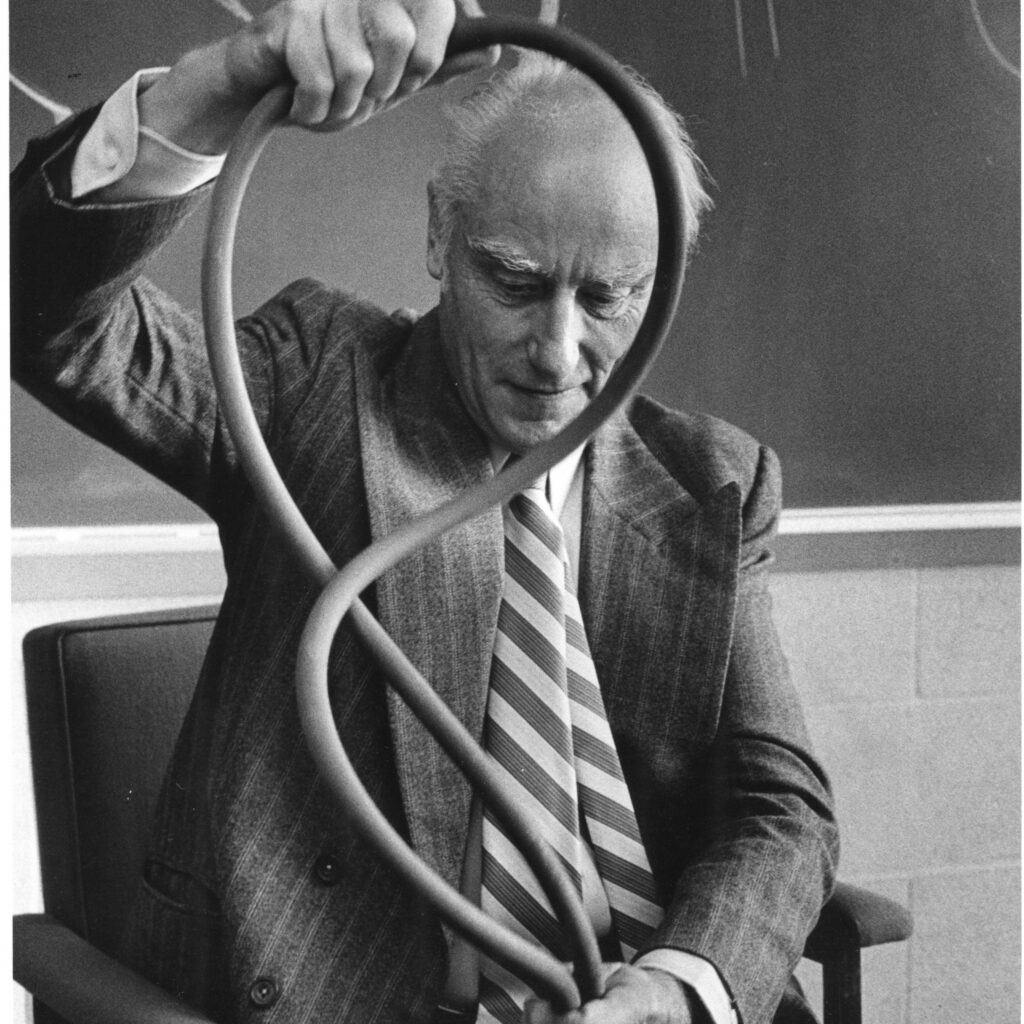 Francis Crick with a double helical model of DNA in 1980.