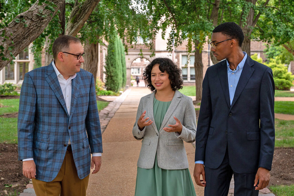 (From left) Chancellor Andrew D. ­Martin speaks with Sarah Del Carmen Camacho, Arts & Sciences Class of 2023, who is an Annika Rodriguez Scholar, Trio Scholar and Mellon Mays Fellow; and Nicholas Armstrong, Law Class of 2023, who is a Michael Schiff Family Scholar in Law, about WashU being a place that allows students to be who they are and achieve success beyond anything they might have thought possible when they entered. (Photo: Sid Hastings/Washington University)
