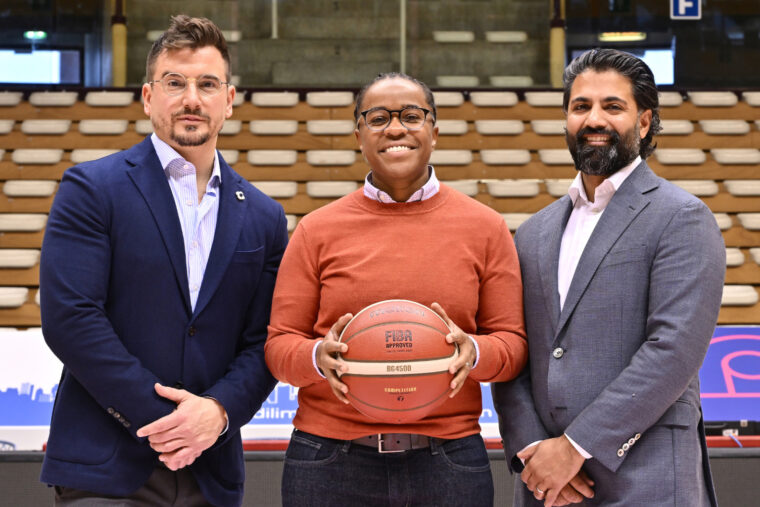Members of the Cotogna Sports Group, including Fitzann Reid (center) and fellow owners Richard de Meo (left) and Prabhdeep Singh Sekhon on the court of the Italian basketball team Pallacanestro Trieste.