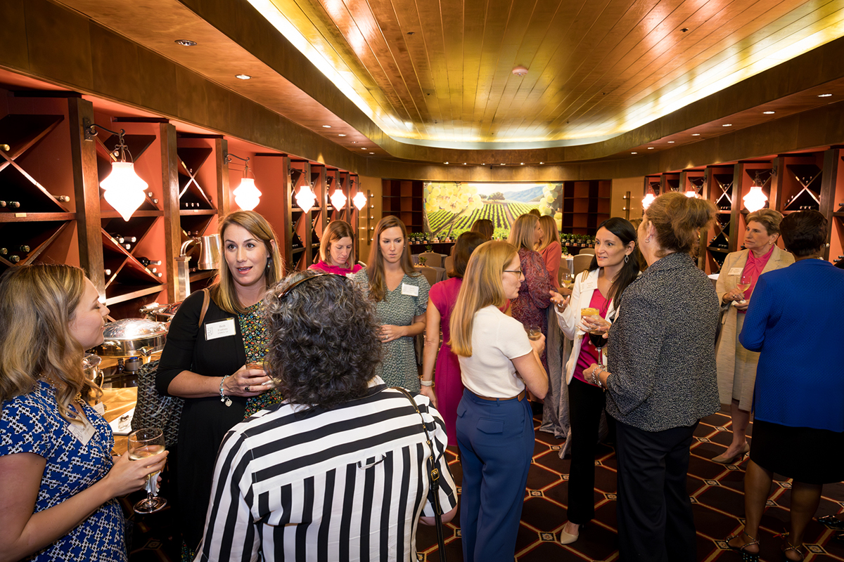 Attendees greet one another at the Power of Women in Business event
