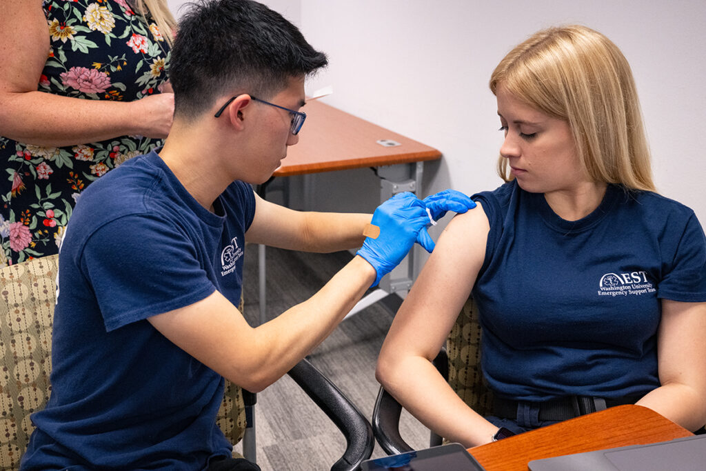 Student gives a vaccine shot