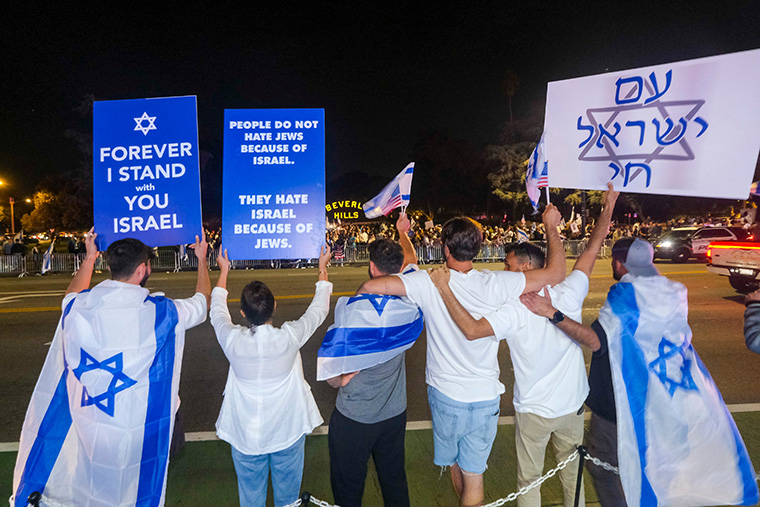 Demonstrators at a rally hold signs in support of Israel