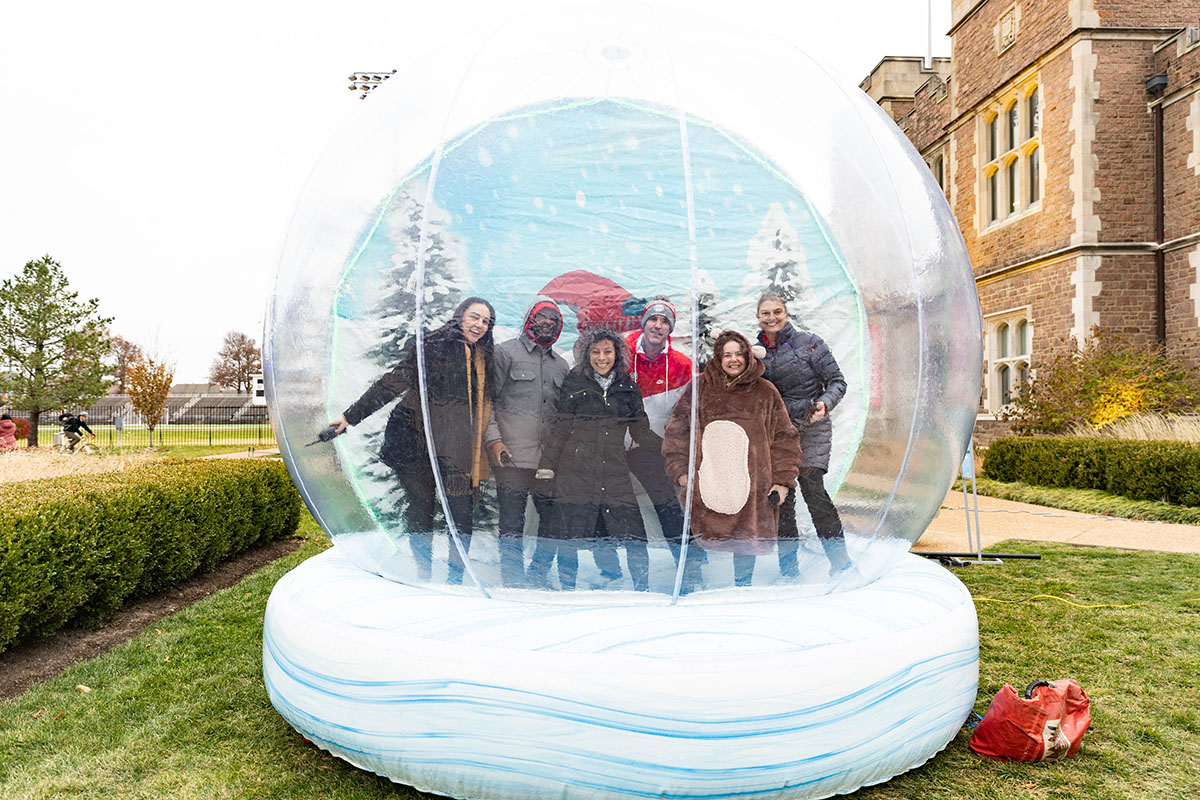 Participants pose in a life-sized snow globe